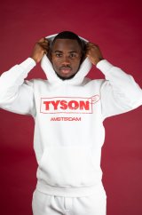 Tyson 2,0 mikina bílá vel. L - muž v bílé bavlněné mikině s kapucí a červeným nápisem TYSON AMSTERDAM na růžovém pozadí