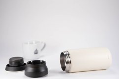 Disassembled Kinto Travel Tumbler White thermos with separate black lid and silver thread, showing 350 ml bottle construction