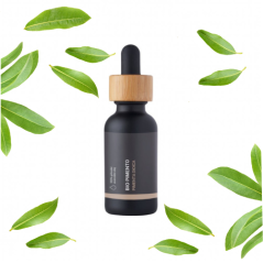 Чорна скляна пляшечка з дерев'яною піпеткою, що містить біо-ефірну олію Pimento, оточена зеленим листям на білому тлі