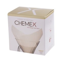 Bílá krabička papírových filtrů Chemex FS-100 se zlatým víkem, na přední straně zobrazený skleněný překapávač s filtrem, balení pro 100 kusů