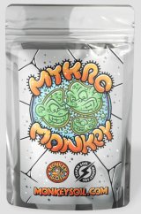 Stříbrný sáček Monkey Mykro 100g s barevnou ilustrací zelených mikroorganismů, oranžovým nápisem a logem MonkeySoil.com